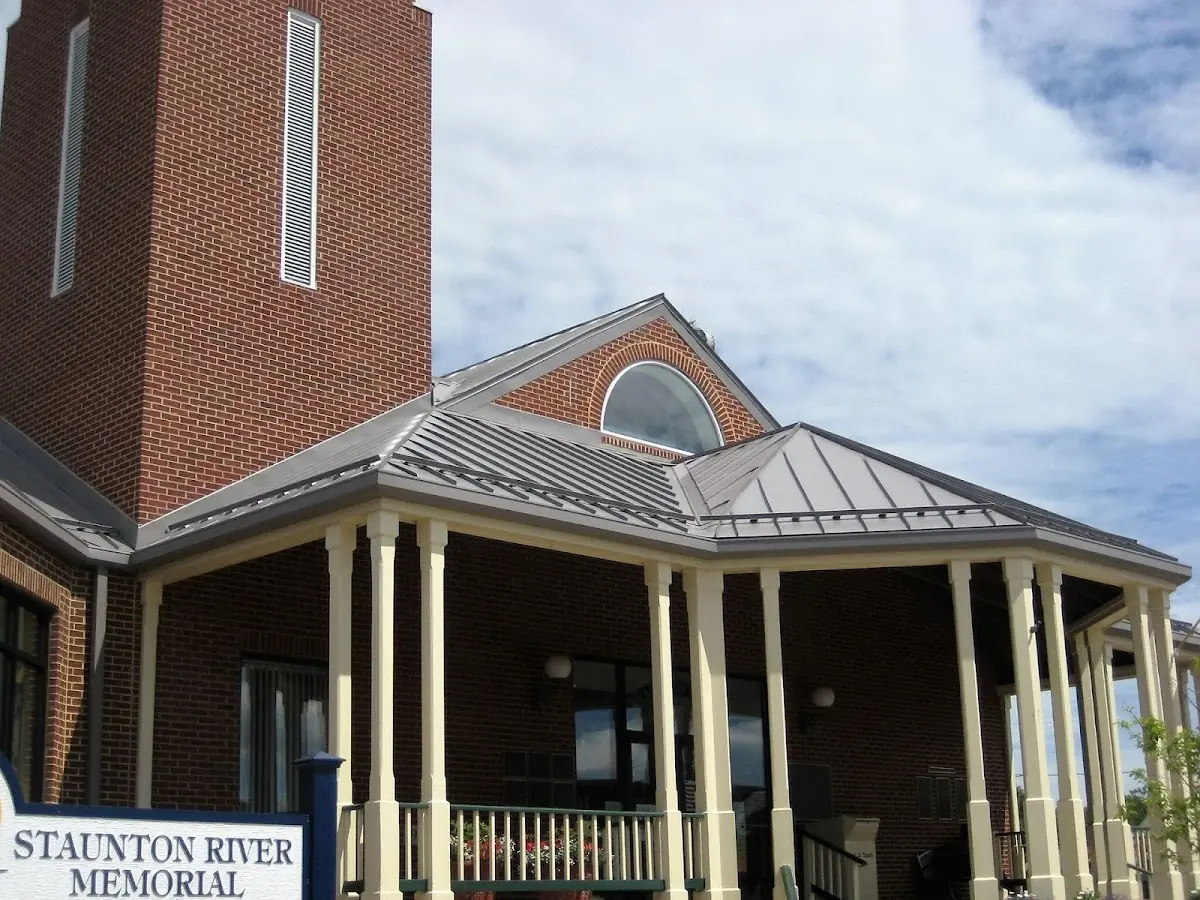 Skilled roofing craftsmen working on a residential roof in Perry